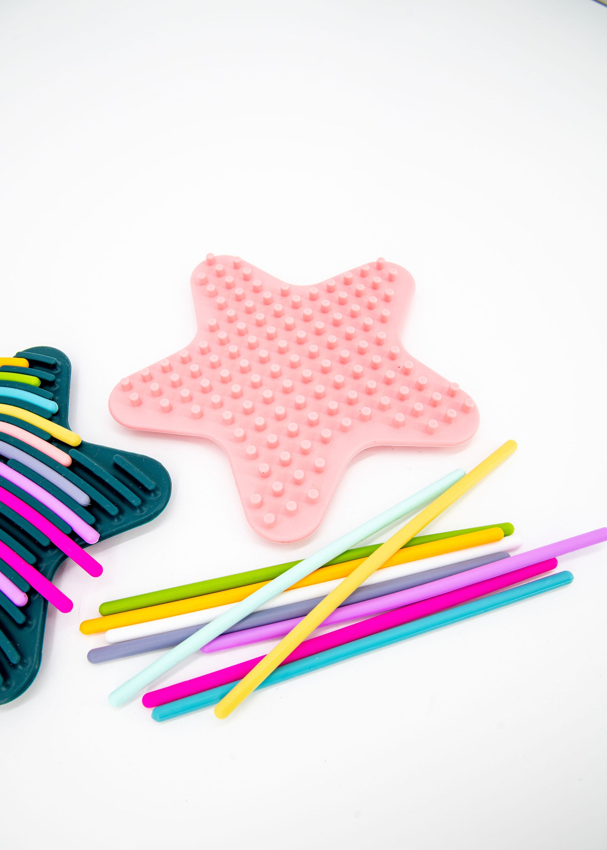Sensory activity board for kids with green and pink star boards and lacing noodles